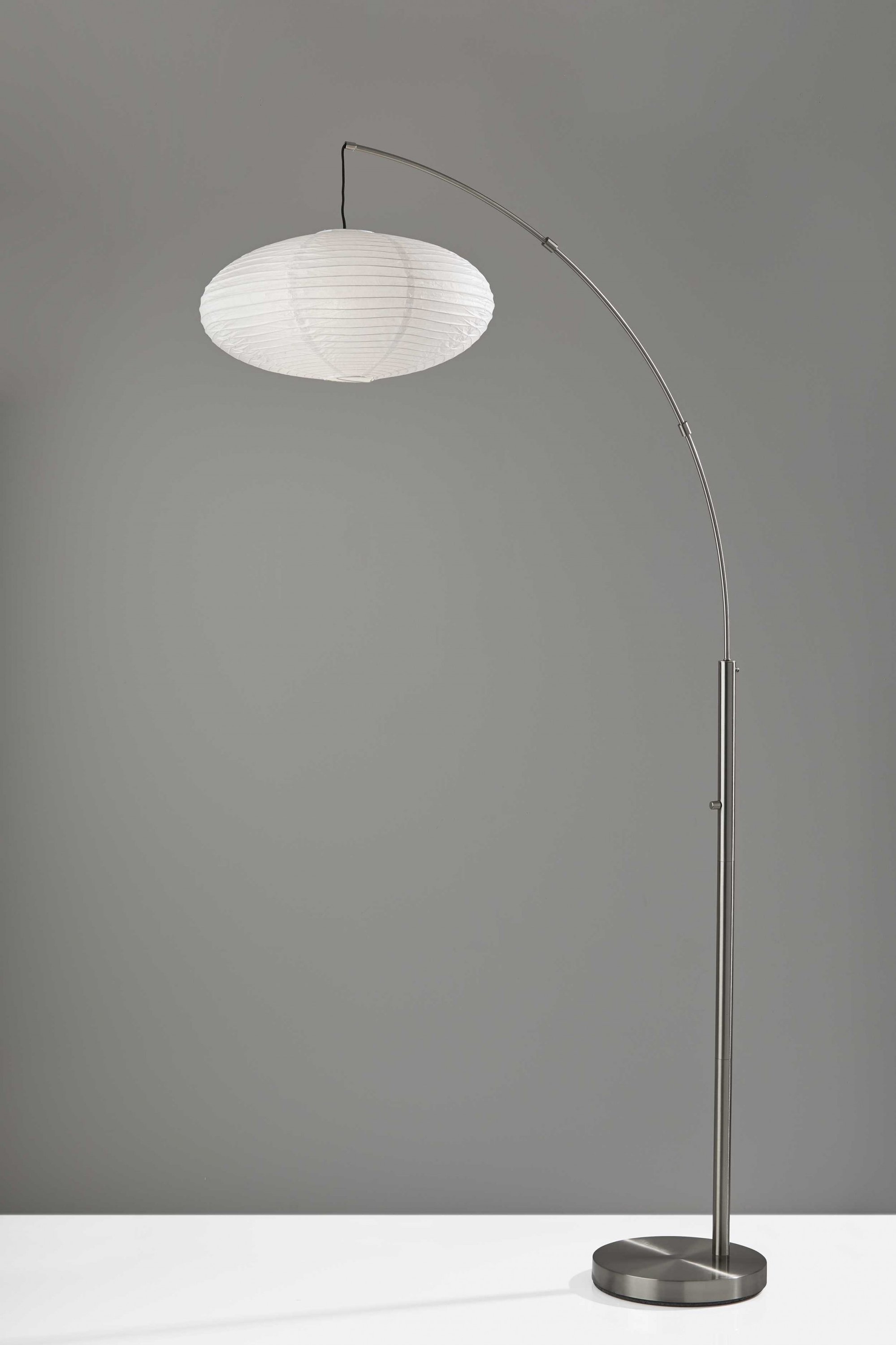 Paper Lantern Floor Lamp featuring a black metal crescent arm and off-white paper shade, providing soft ambient lighting.