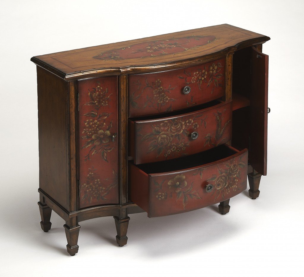 A beautifully crafted red wooden console cabinet with hand-painted design, featuring three felt-lined drawers and antique brass hardware.