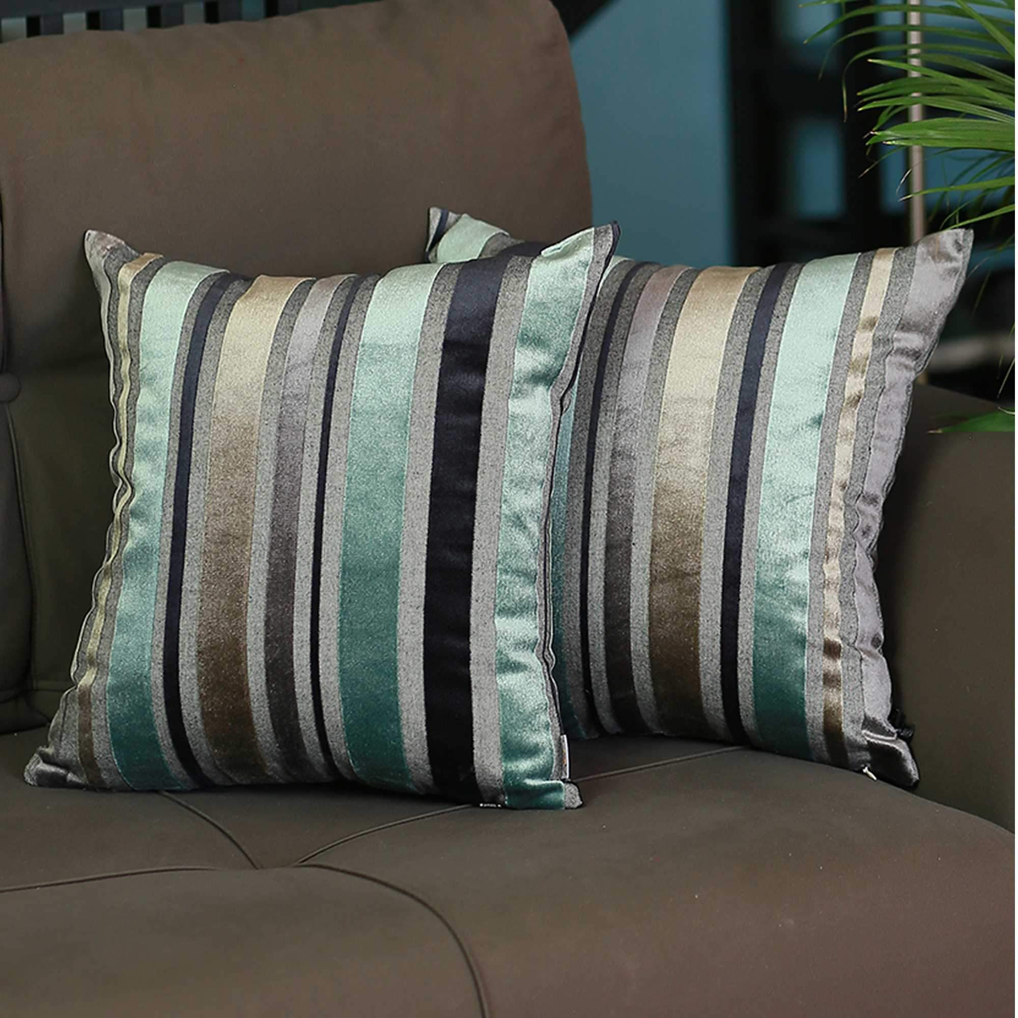 Set of 2 blue variegated stripe decorative pillow covers made from soft velvet fabric, featuring hidden zipper closure and elegant binding edges.
