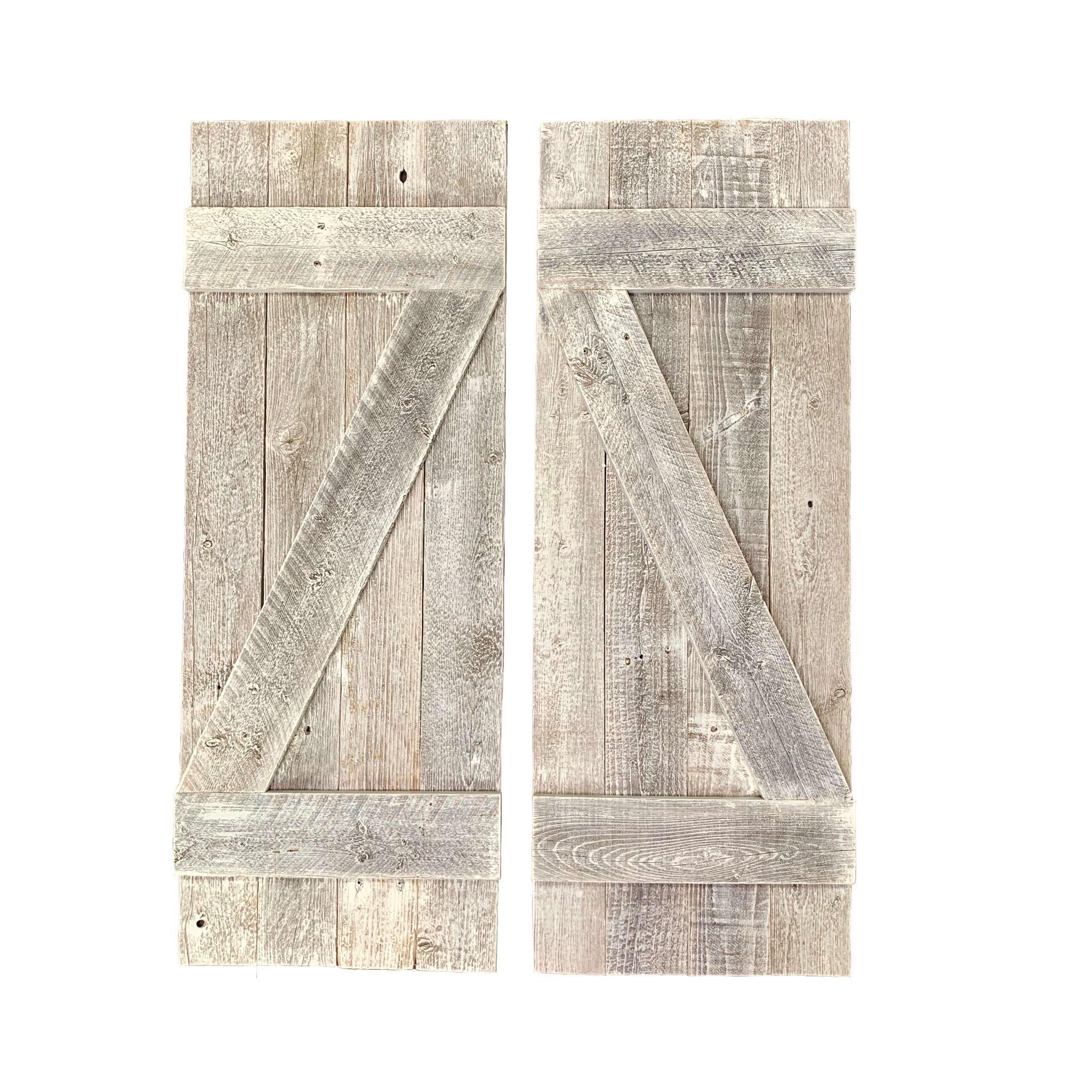 Set of two rustic weathered grey wood decorative window shutters, showcasing a charming farmhouse style with a weathered finish.