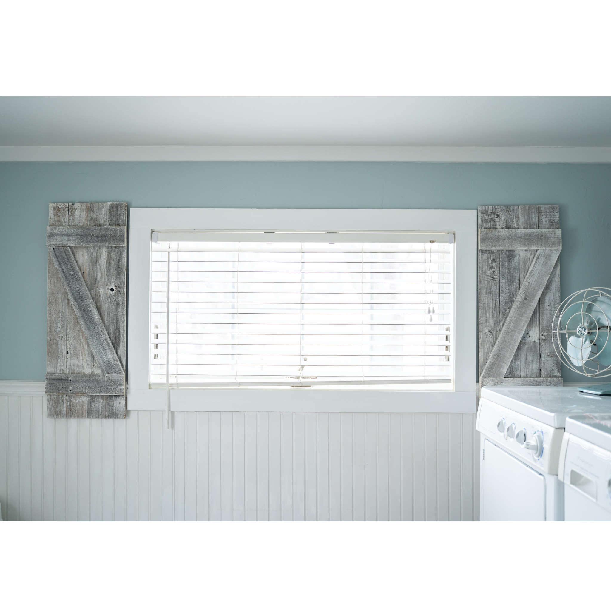 Set of two rustic weathered grey wood decorative window shutters, showcasing a charming farmhouse style with a weathered finish.