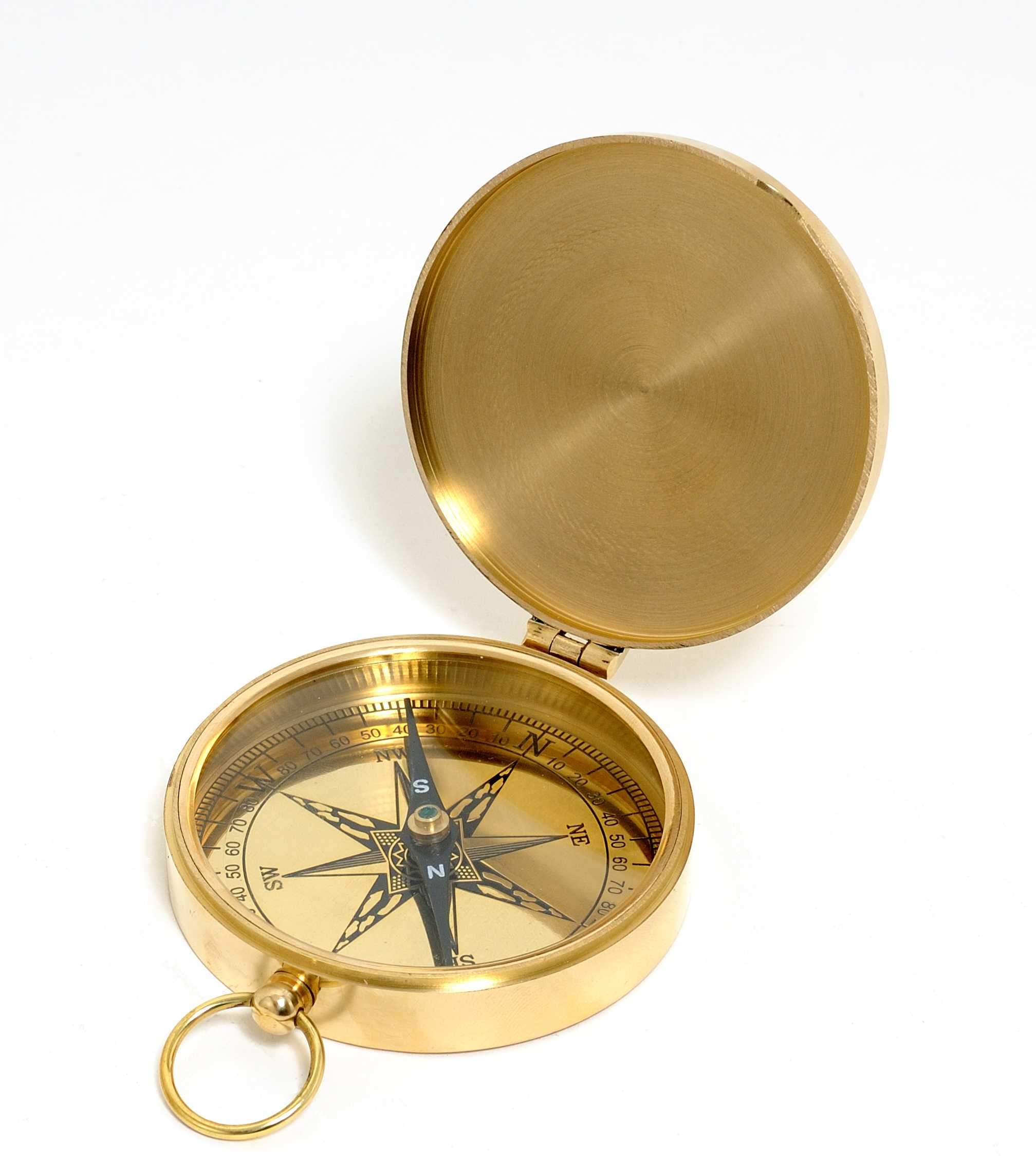 A shiny brass marine compass with a lid, showcasing its elegant design and craftsmanship, perfect for nautical decor.