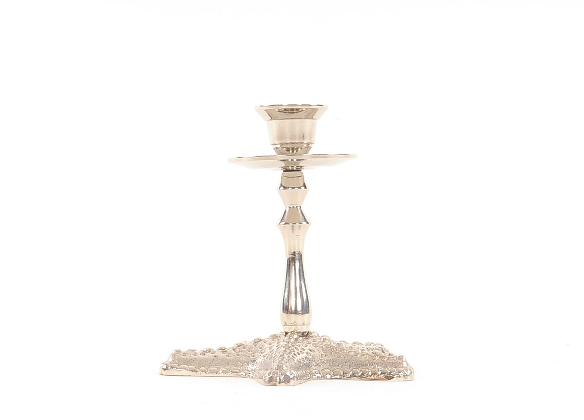 A beautiful silver finish starfish taper candle holder made of solid brass, showcasing a unique starfish design.