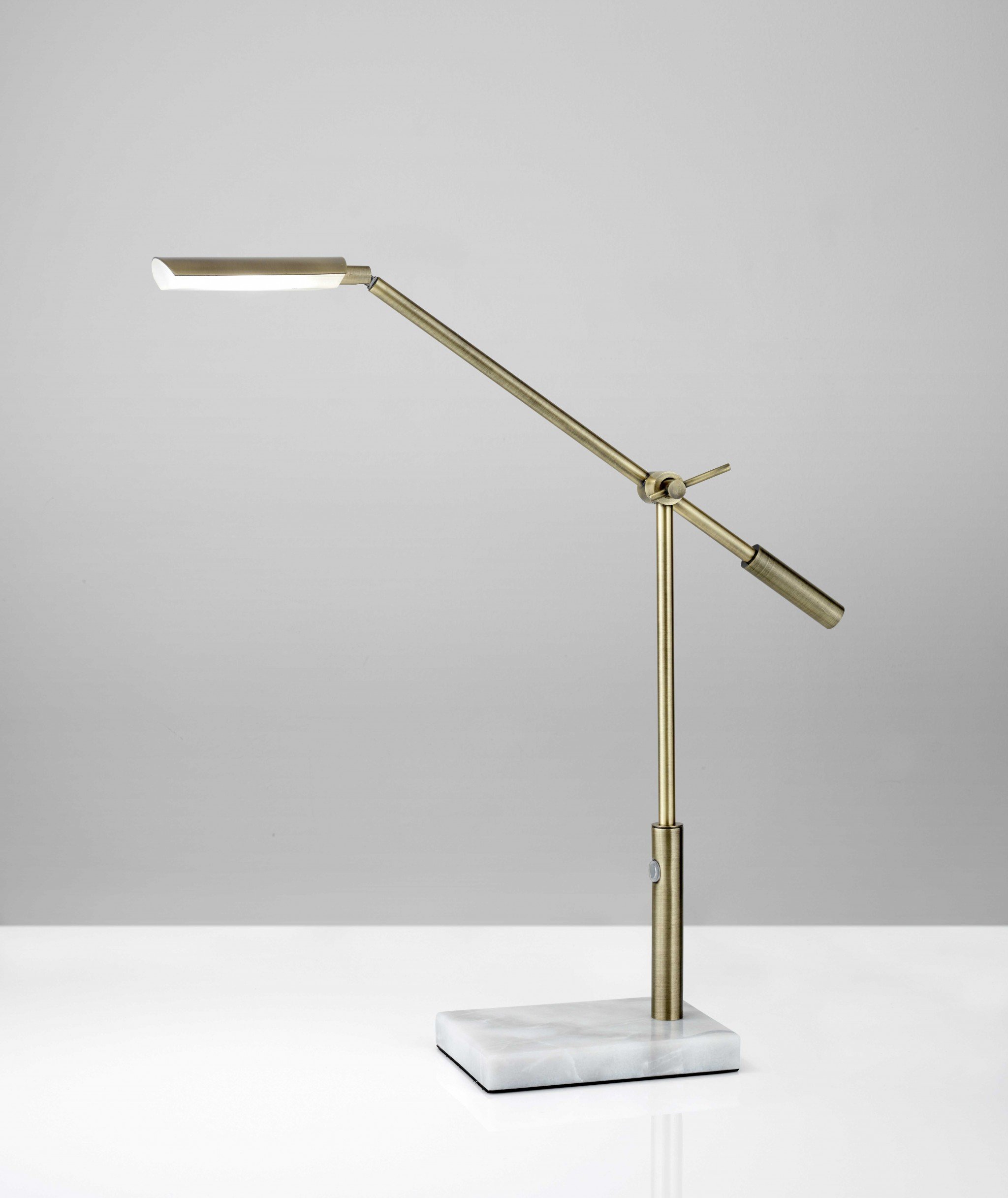 Sleek brass metal adjustable and dimmable LED desk lamp with white marble base, showcasing industrial and elegant design.