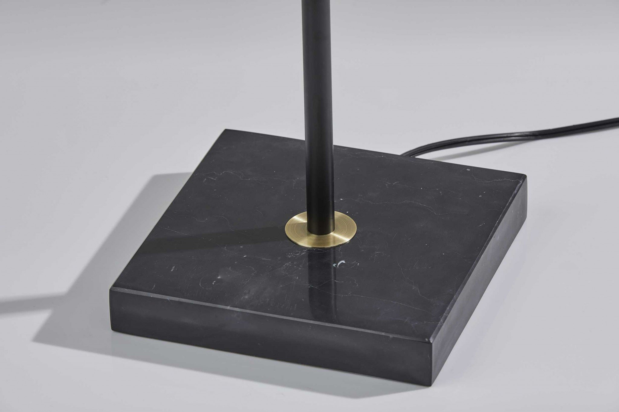 Sleek torchiere lamp featuring black metal base and frosted alabaster glass shade, designed for bright ambient lighting.