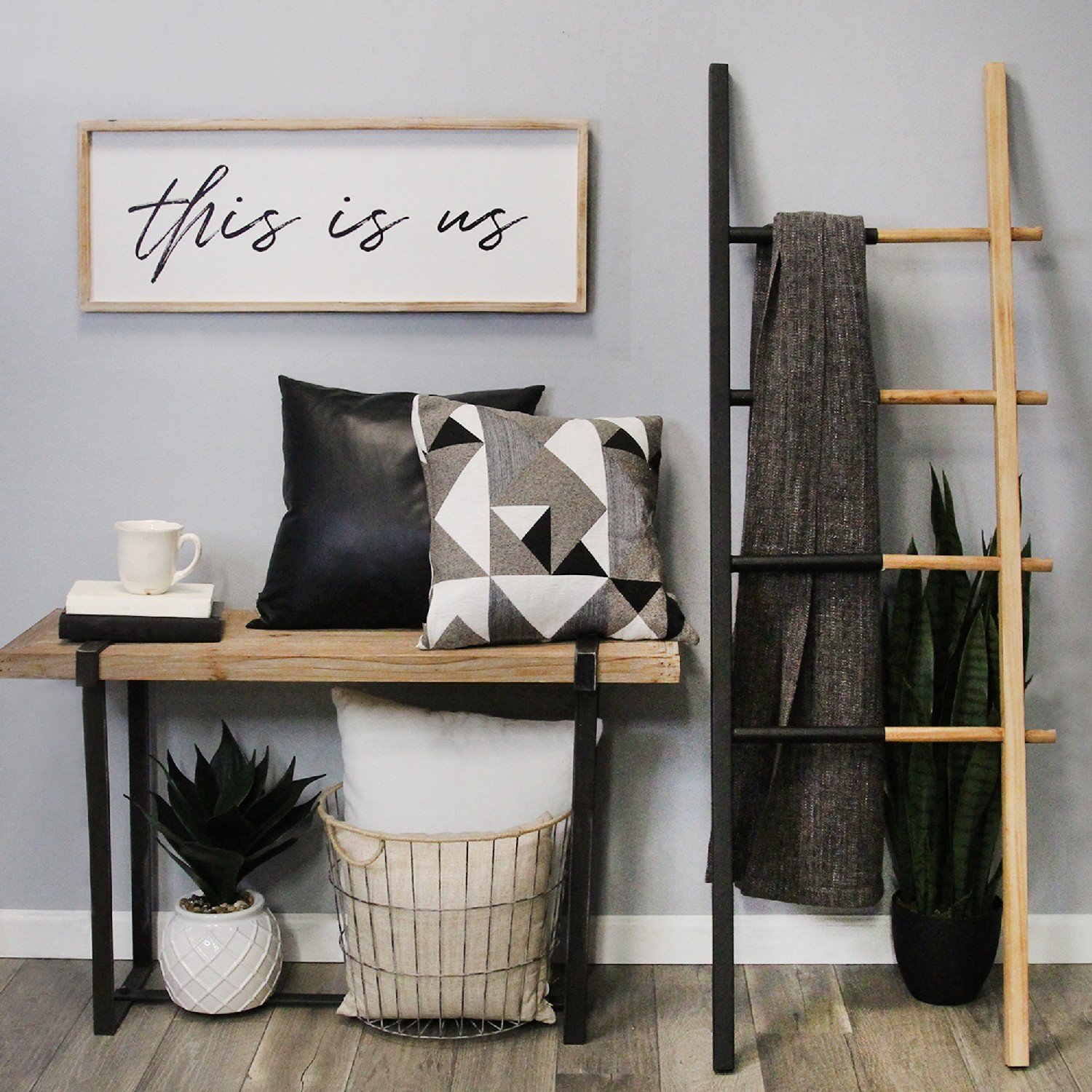 Handcrafted 'This Is Us' wood framed wall art in black script font, showcasing family pride with a natural wood frame.