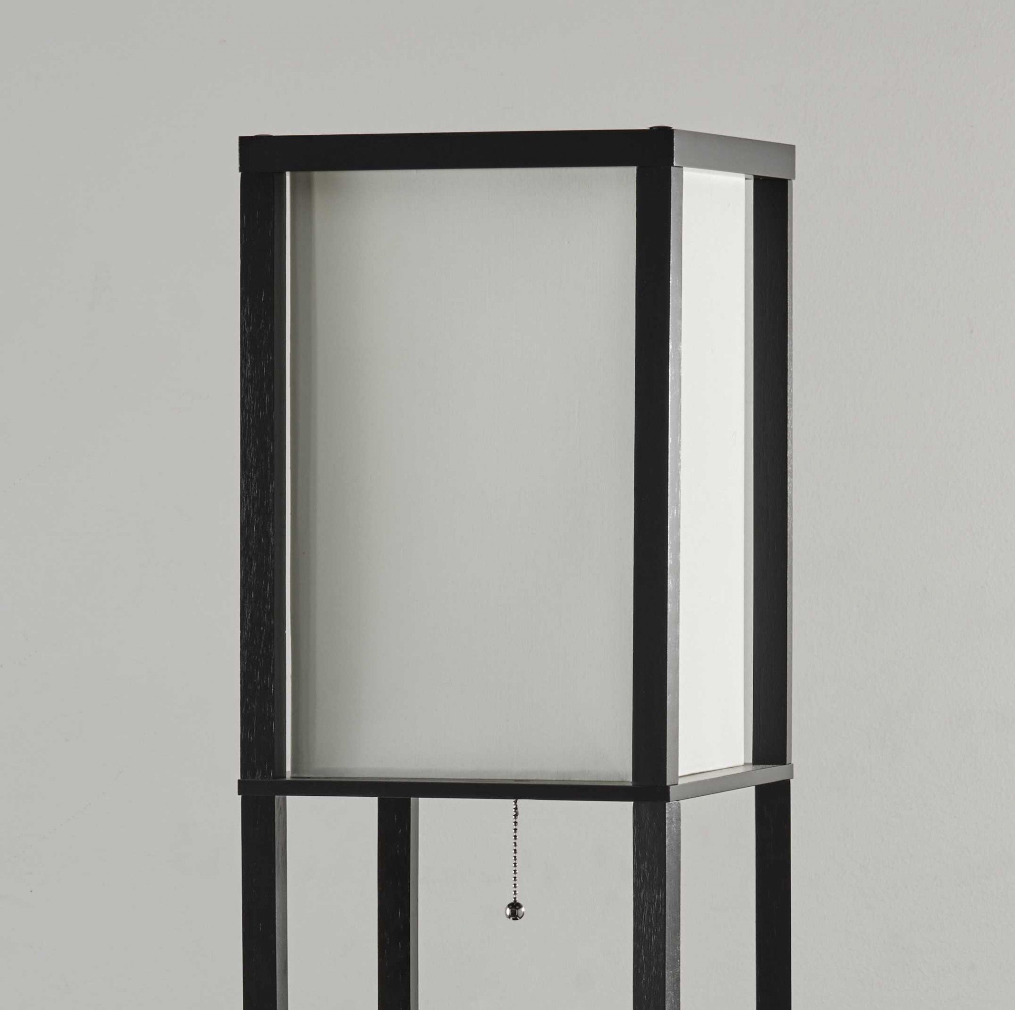 Three drawer and shelf floor lamp with black wood finish and off-white cotton shade, featuring brushed steel pull chain switch.
