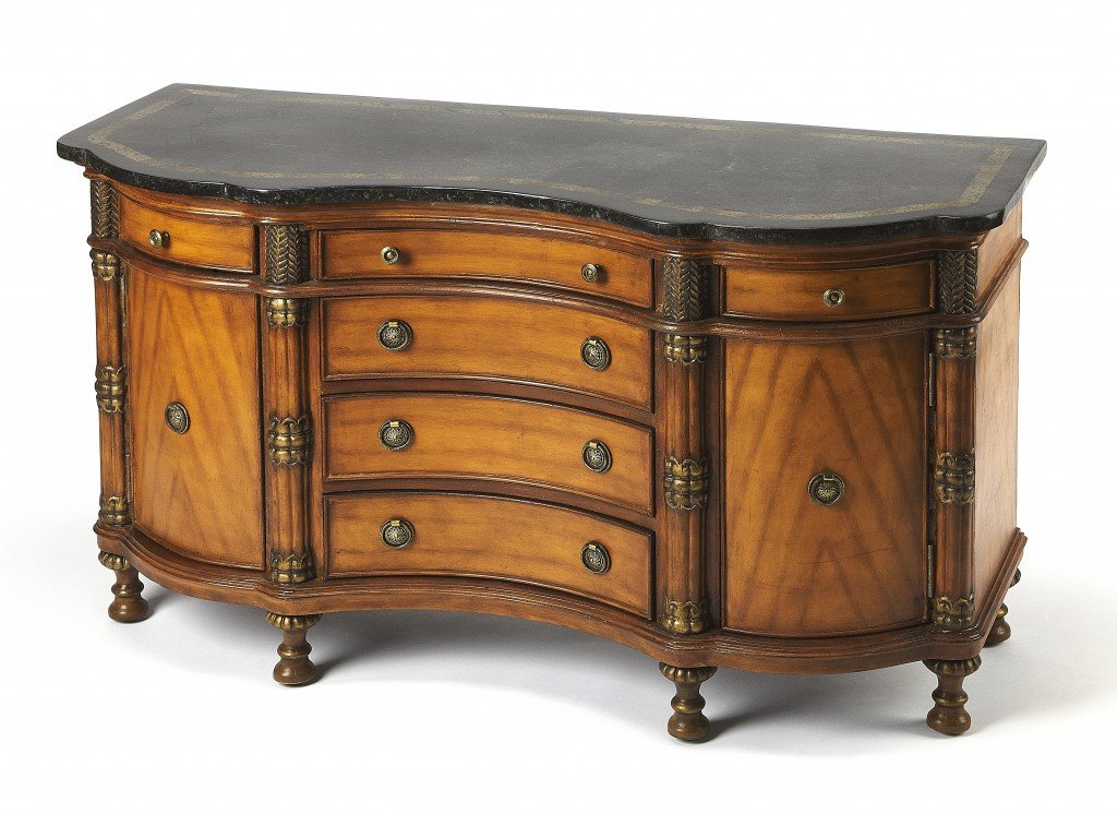 Traditional carved wooden credenza featuring a black fossil stone top with snake skin insert and antique brass hardware.