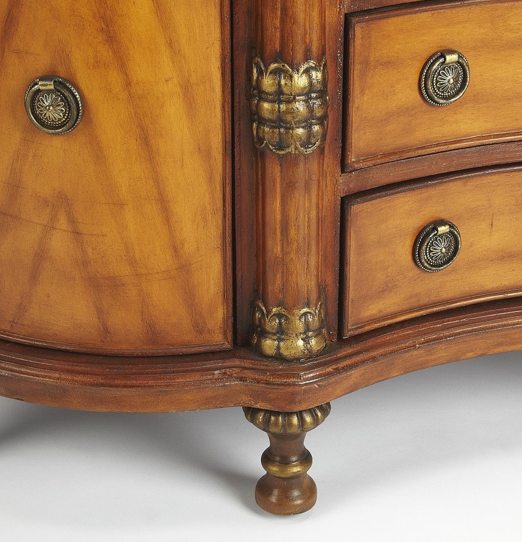 Traditional carved wooden credenza featuring a black fossil stone top with snake skin insert and antique brass hardware.