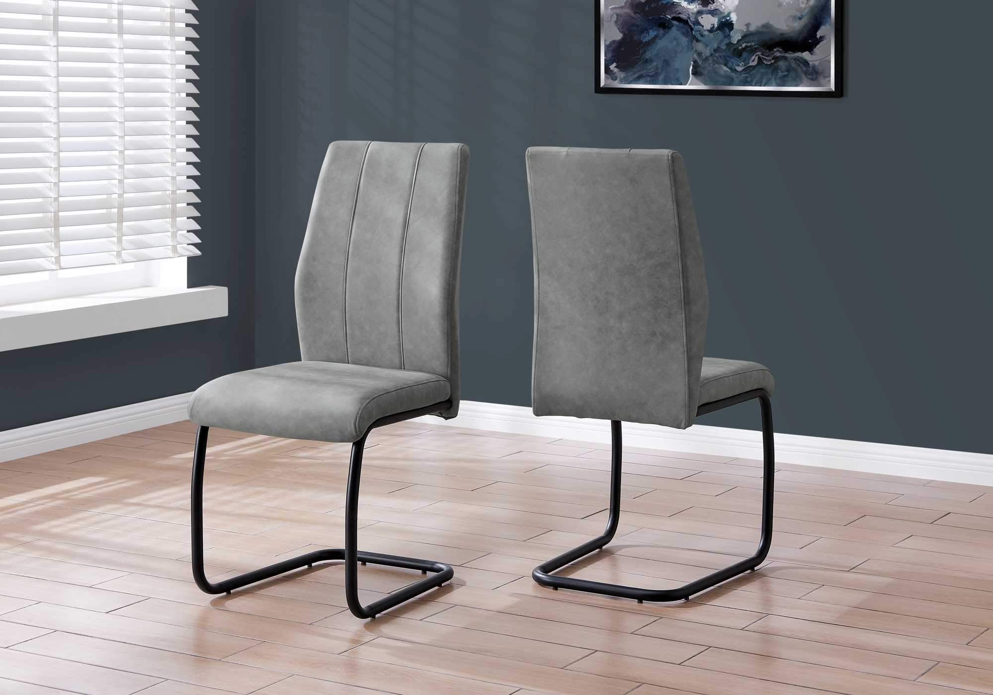 Set of two stylish black metal and polyester dining chairs, featuring a modern design and comfortable foam padding.