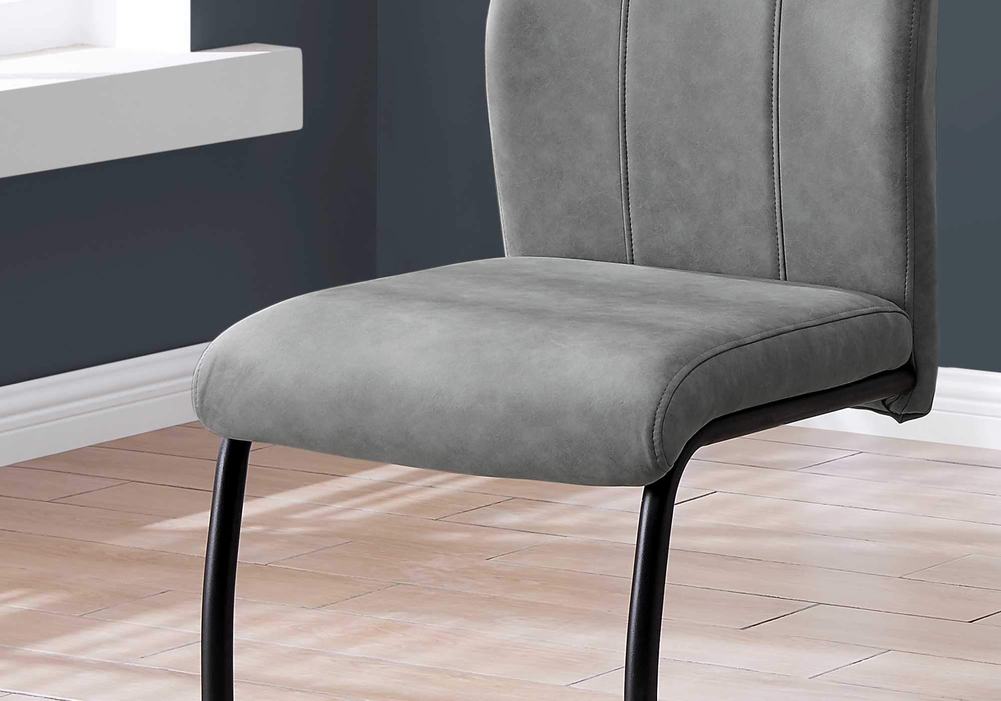 Set of two stylish black metal and polyester dining chairs, featuring a modern design and comfortable foam padding.