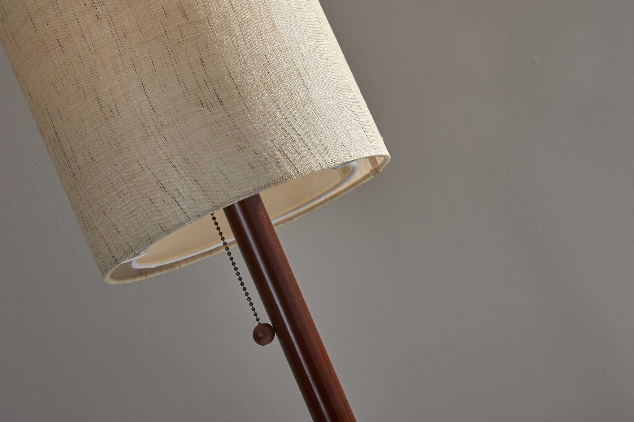 Walnut wood finish floor lamp with a slim cylindrical shade, featuring a wooden pole and a decorative wood ball pull-chain.