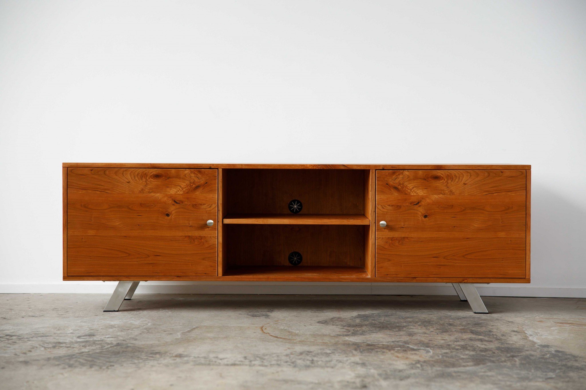 Warm Natural Cherry and Steel TV Stand showcasing mid-century modern design with spacious storage for media accessories.