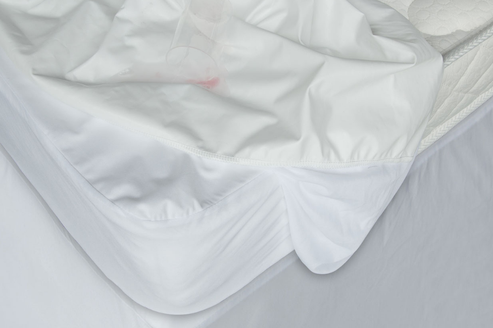 White Medium Weight Hypoallergenic Twin Down Alternative Comforter displayed on a bed, showcasing its soft texture and neutral color.