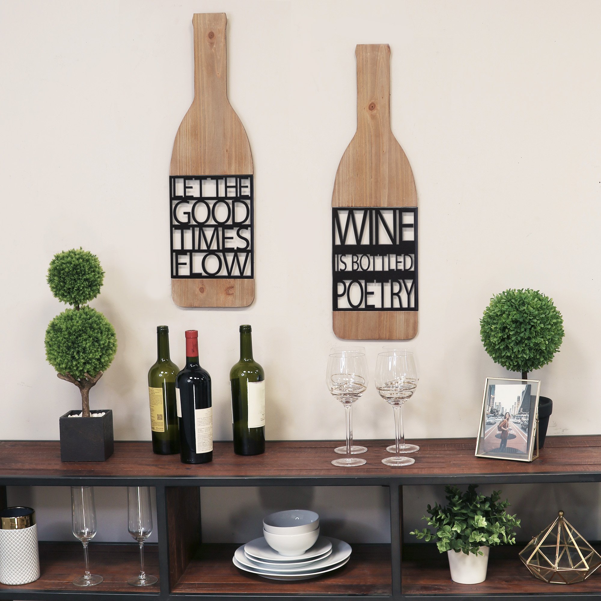 Elegant wall decor featuring the phrase 'Wine is Bottled Poetry' in black metal with natural wood accents, perfect for wine lovers.