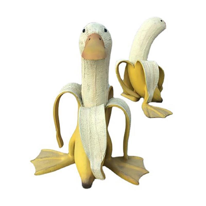 A whimsical Art Banana Duck Statue featuring a banana peel design with a duck head and feet, perfect for garden and desktop decor.