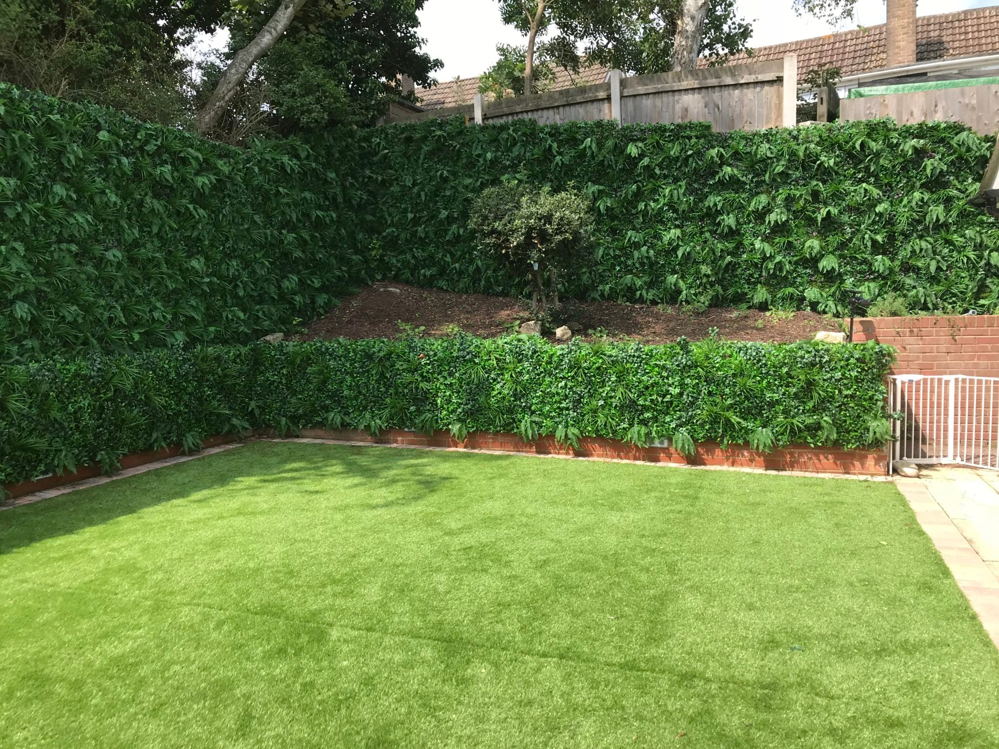 Artificial Instant Green Wall Hedge Panel featuring mixed plants including ferns, ivy leaves, and colorful foliage, measuring 100cm x 100cm.