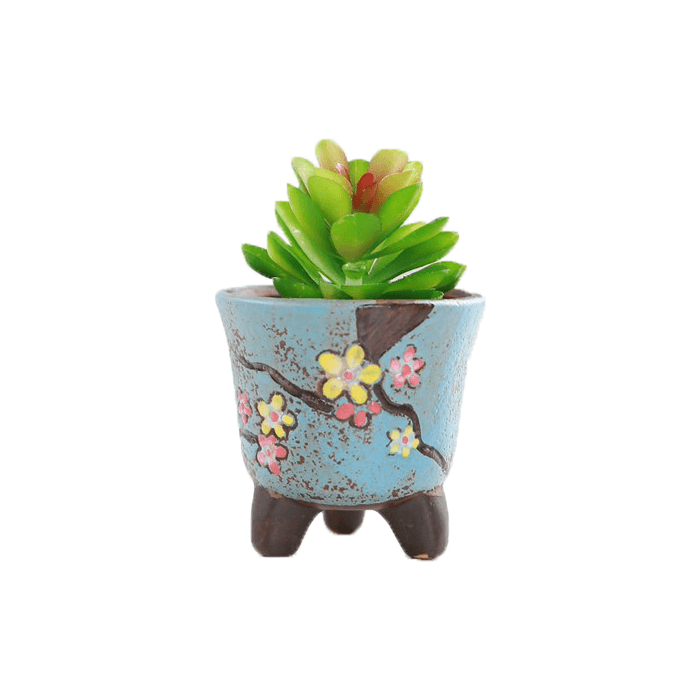 Blue cup shaped ceramic succulent pot with floral design, featuring three legs and drainage hole, perfect for indoor plants.