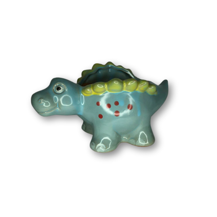 A vibrant blue ceramic flower pot shaped like a stegosaurus, featuring a drainage hole at the bottom.