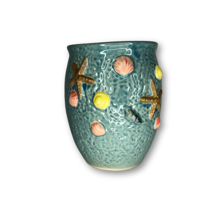 A blue tall round pot featuring raised sea shell designs, perfect for indoor or outdoor plants.