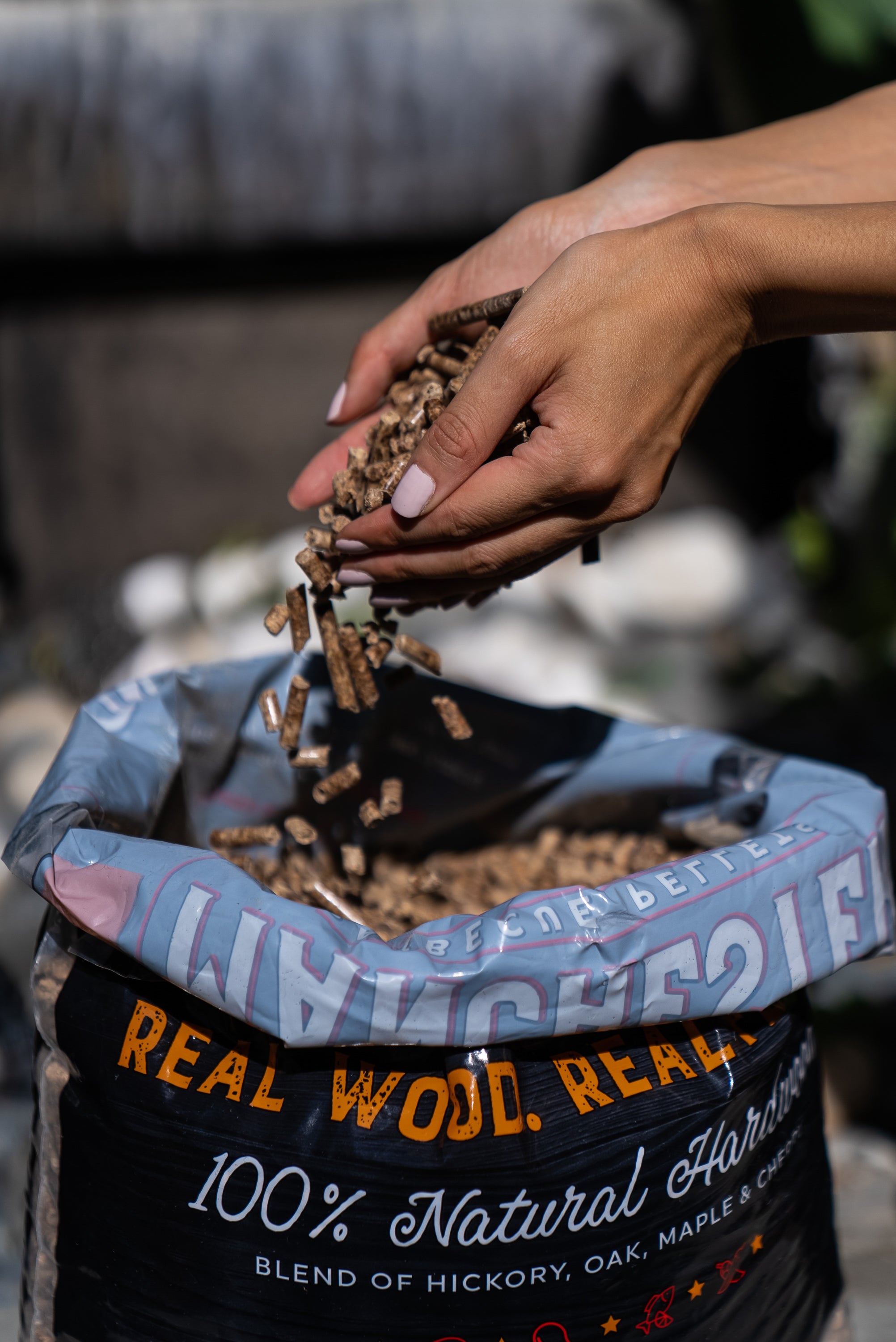 A 20lb bag of Manchester Barbecue Pellets featuring a blend of Hickory, Oak, Maple, and Cherry wood, ideal for grilling and smoking.