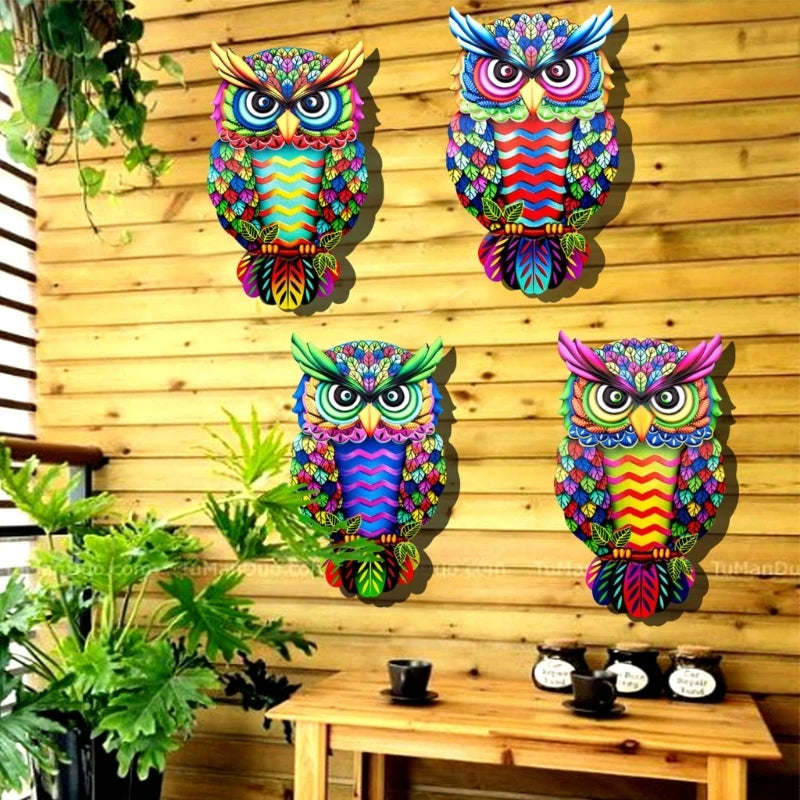 A vibrant metal owl sculpture featuring colorful designs, perfect for wall decoration in homes or gardens.