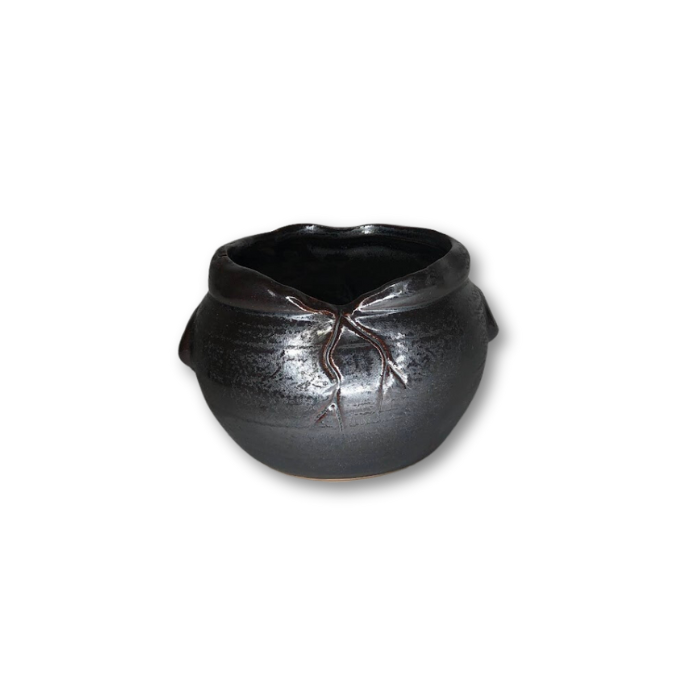 A stylish metallic black ceramic pot featuring a unique cracked rim design, perfect for small plants.