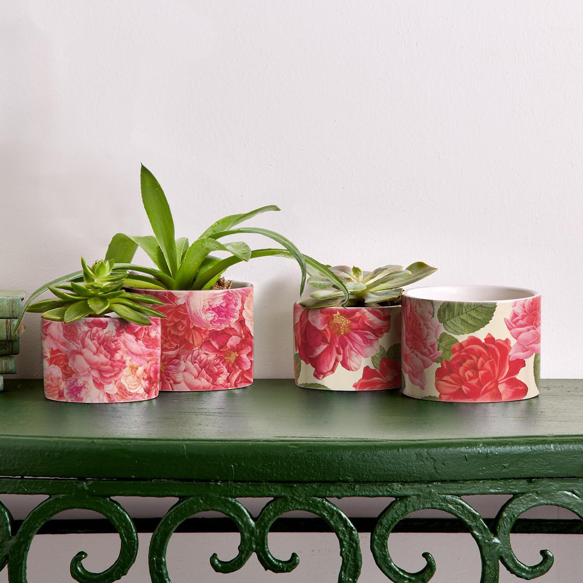 Two stunning Rose Marie floral cachepots in pink and red ceramic, showcasing intricate rose patterns.