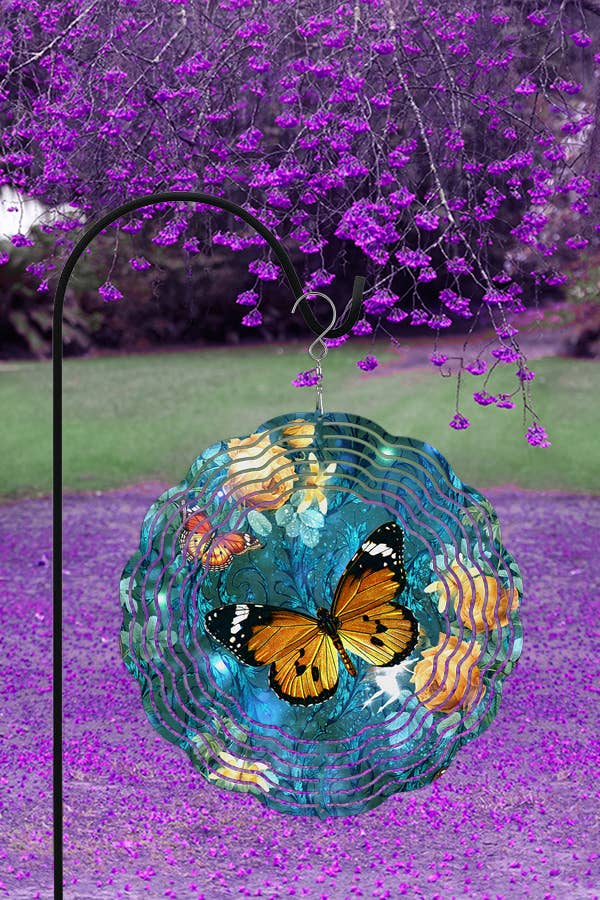 A vibrant 10-inch aluminum wind spinner featuring a golden butterfly design on a blue background, elegantly hanging outdoors.