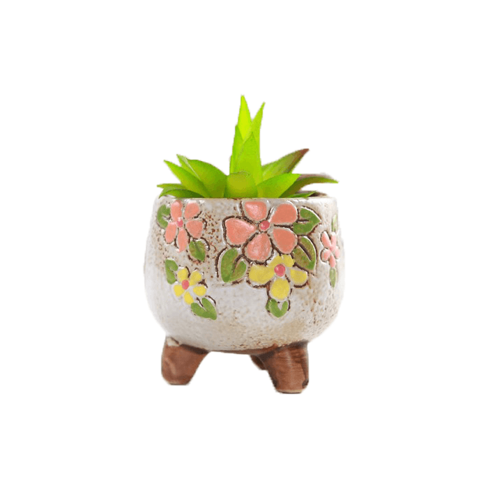 White oval shaped ceramic succulent pot with floral design, featuring three legs and drainage hole, ideal for indoor plants.