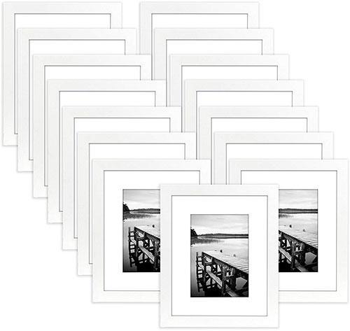 A collection of 15 white 8x10 picture frames with beveled mats, displaying various photos in a stylish arrangement.