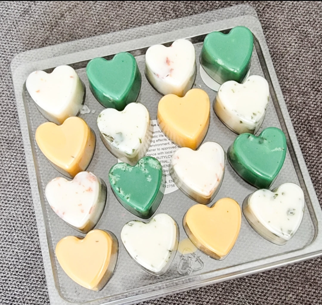 A collection of 16 heart-shaped wax melts in various colors, showcasing their handmade quality and eco-friendly nature.