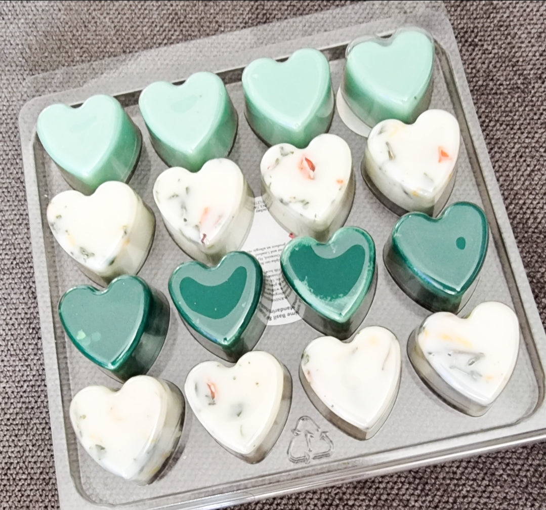 A collection of 16 heart-shaped wax melts in various colors, showcasing their handmade quality and eco-friendly nature.