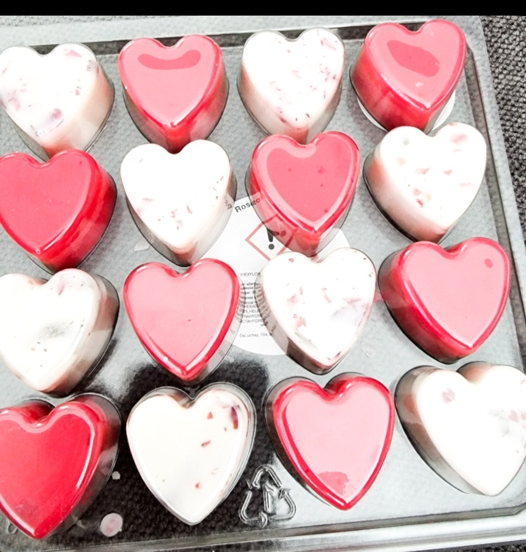 A collection of 16 heart-shaped wax melts in various colors, showcasing their handmade quality and eco-friendly nature.