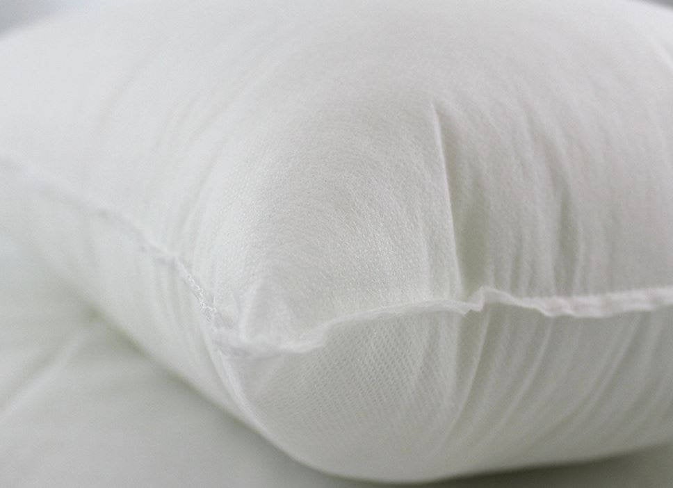 A plush hypoallergenic polyester pillow insert in 16x24 or 24x16 size, showcasing its soft texture and durable cotton blend fabric.
