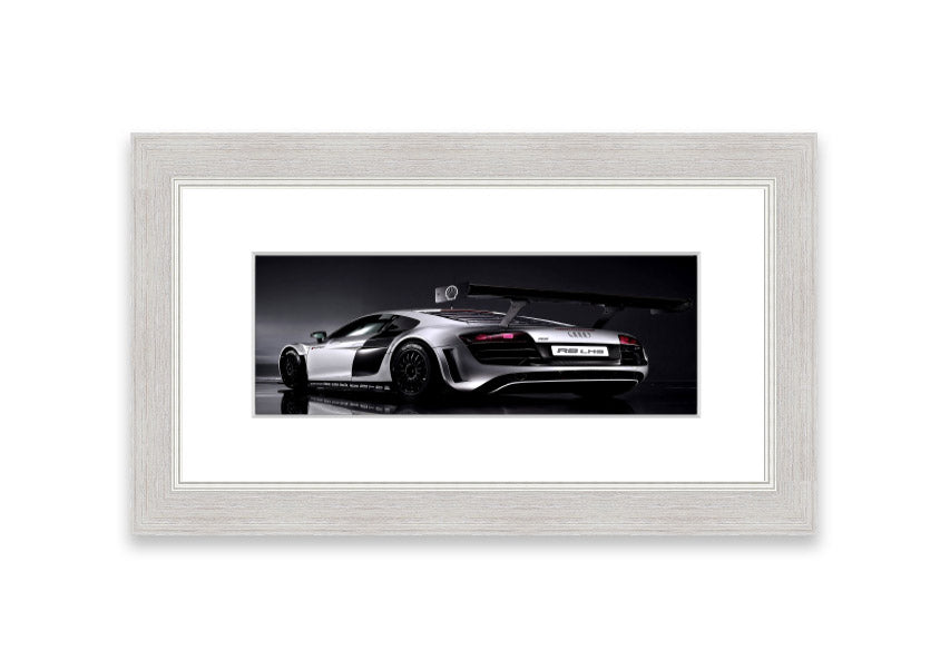 Framed print of the 2010 Audi R8 Lms, showcasing its sleek design and vibrant colors, ready to hang.
