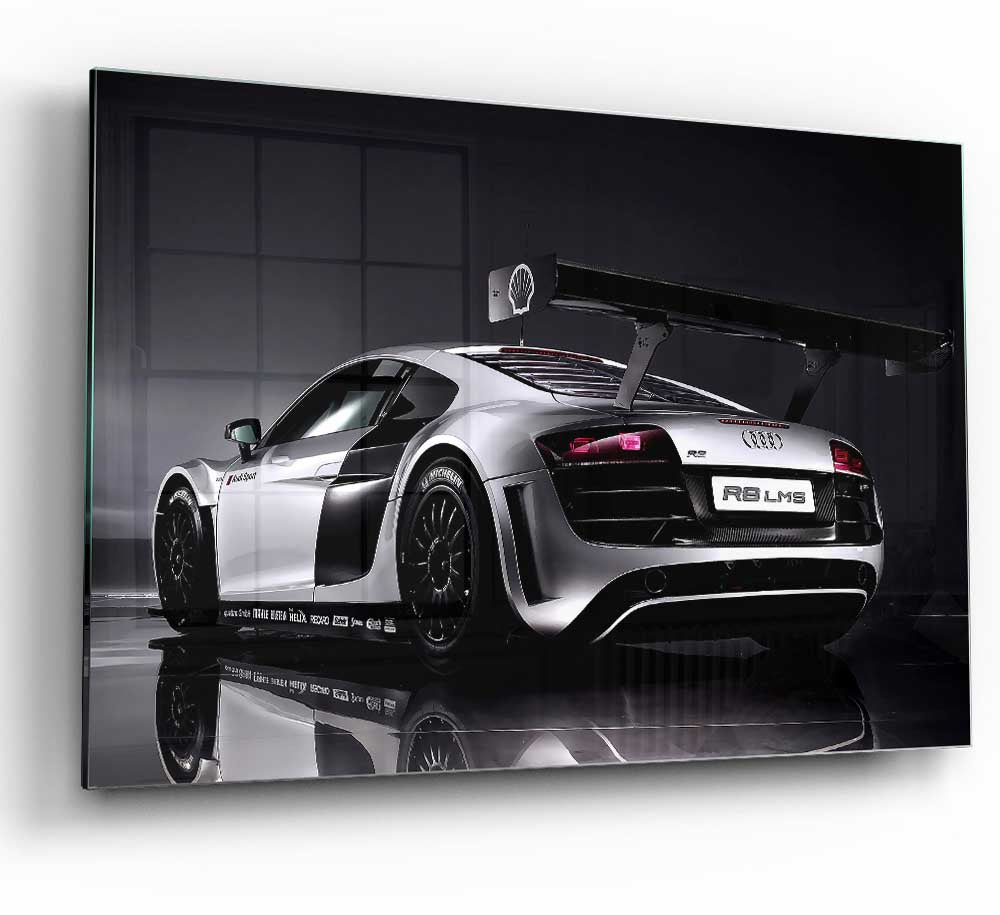 A modern glass print featuring the 2010 Audi R8 Lms, showcasing its sleek design and vibrant colors.