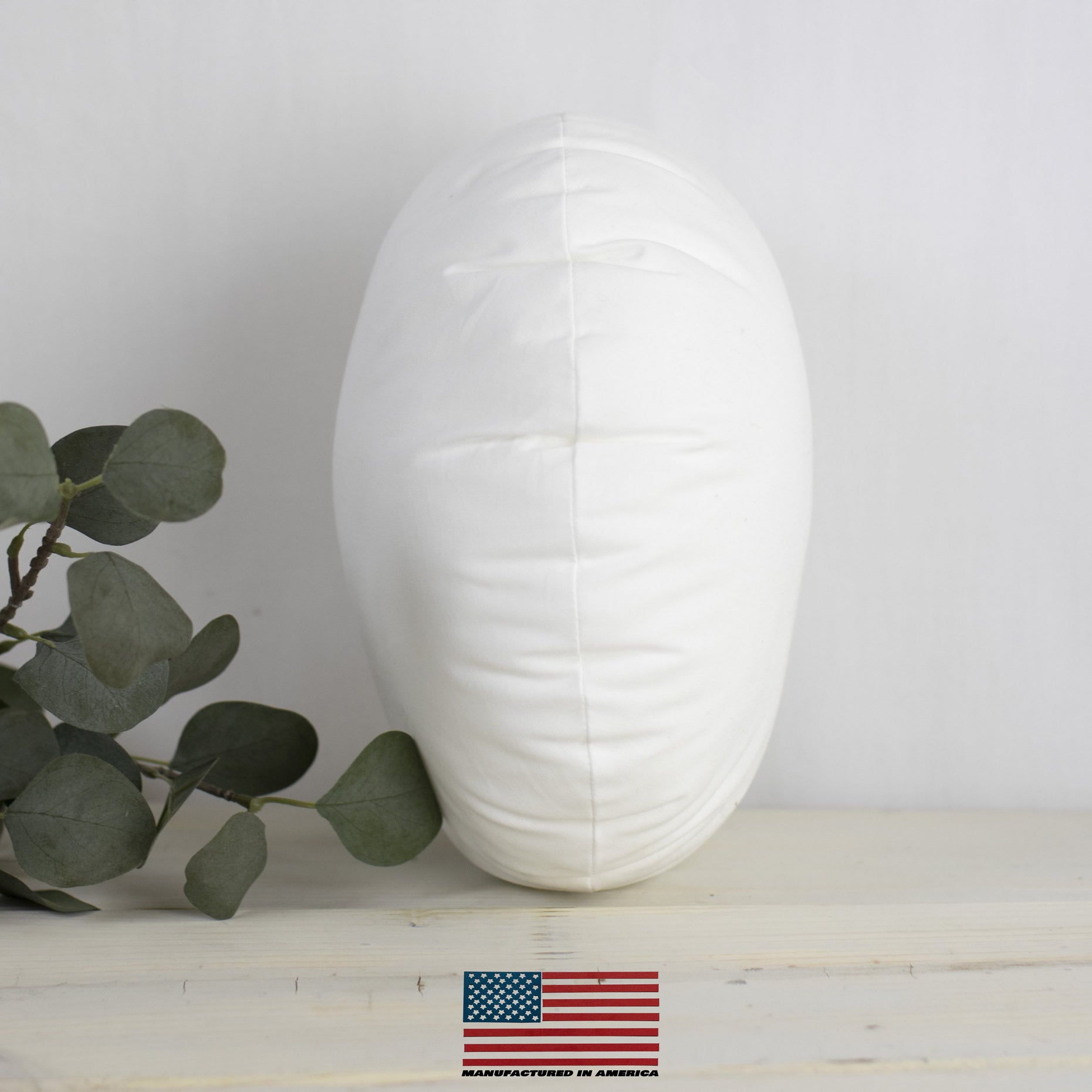 A 23-inch round pillow insert made of hypoallergenic polyester, featuring a durable woven cotton blend outer shell, ideal for indoor and outdoor use.