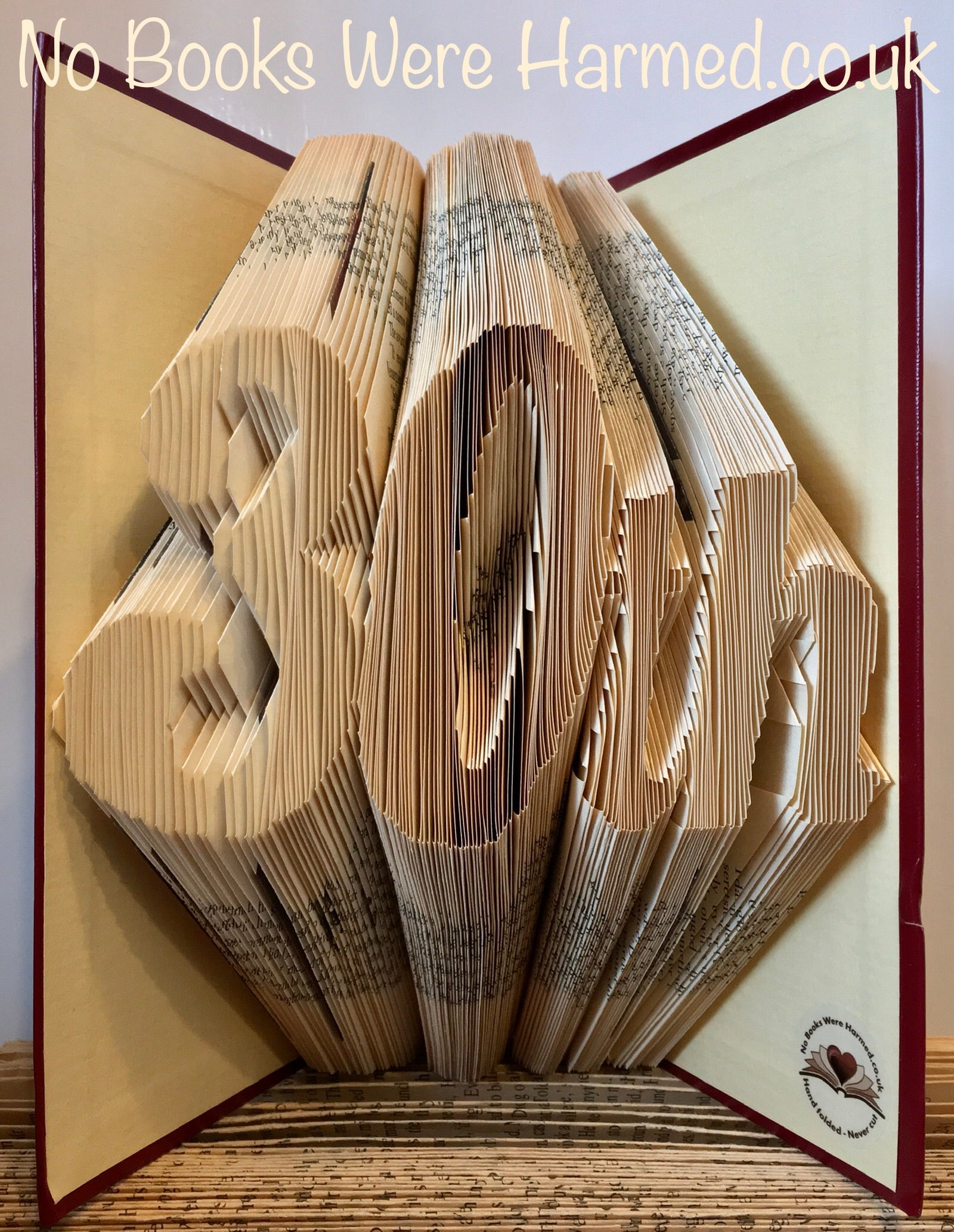 Handcrafted book art made from vintage books, featuring intricate folds and unique designs, perfect for a pearl anniversary gift.
