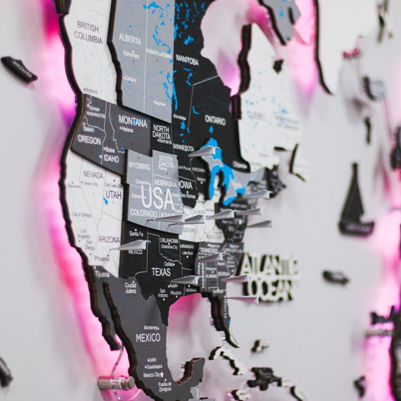 3D LED Wooden World Map Nordik displayed on a wall, showcasing intricate details and vibrant LED lighting.