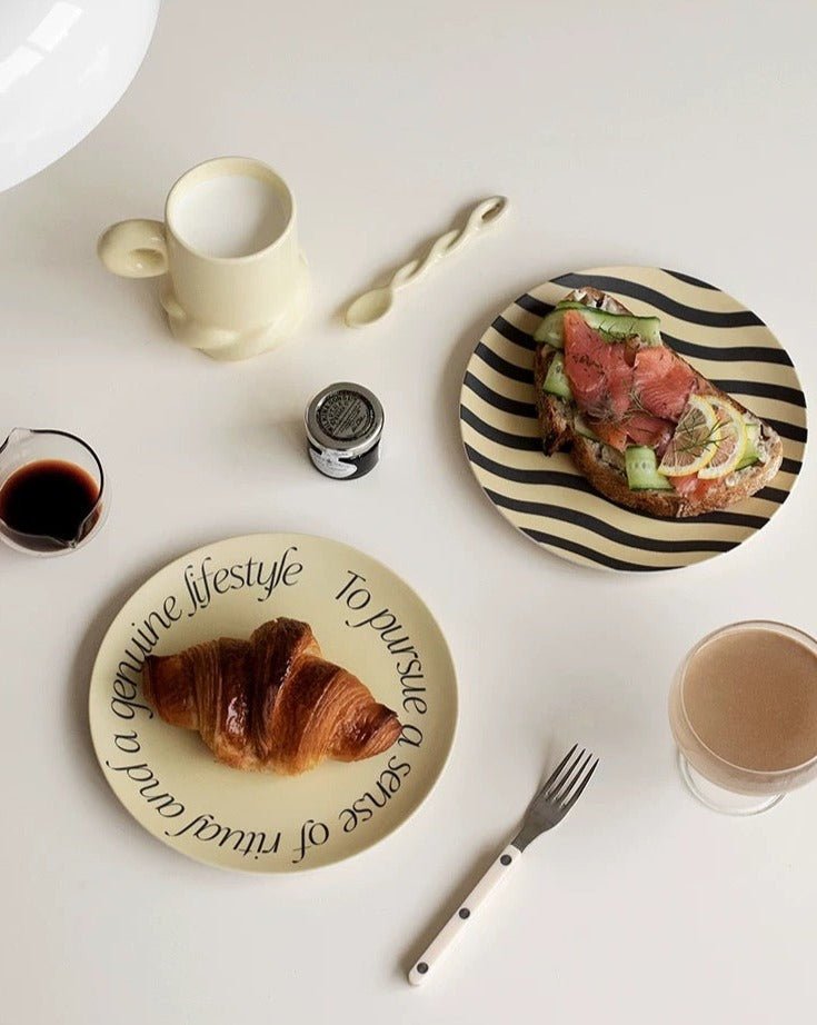 A set of four modern bamboo fiber plates featuring mushroom and croissant prints, showcasing eco-friendly design and vibrant colors.