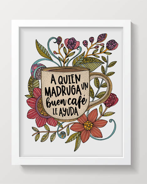 A colorful coffee mug featuring the quote 'A quien madruga un buen cafe le ayuda' surrounded by vibrant flowers and leaves.