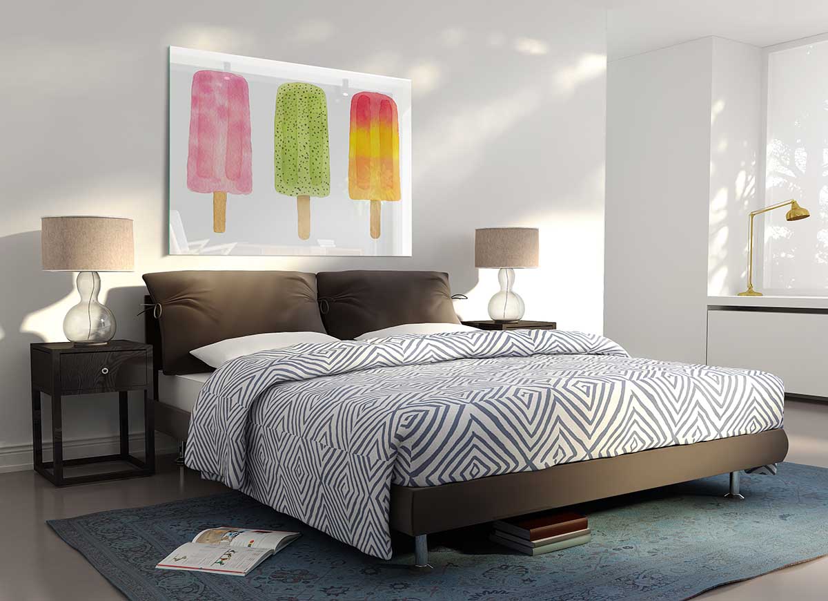 A modern glass print featuring a colorful trio of lollies, perfect for home decor.