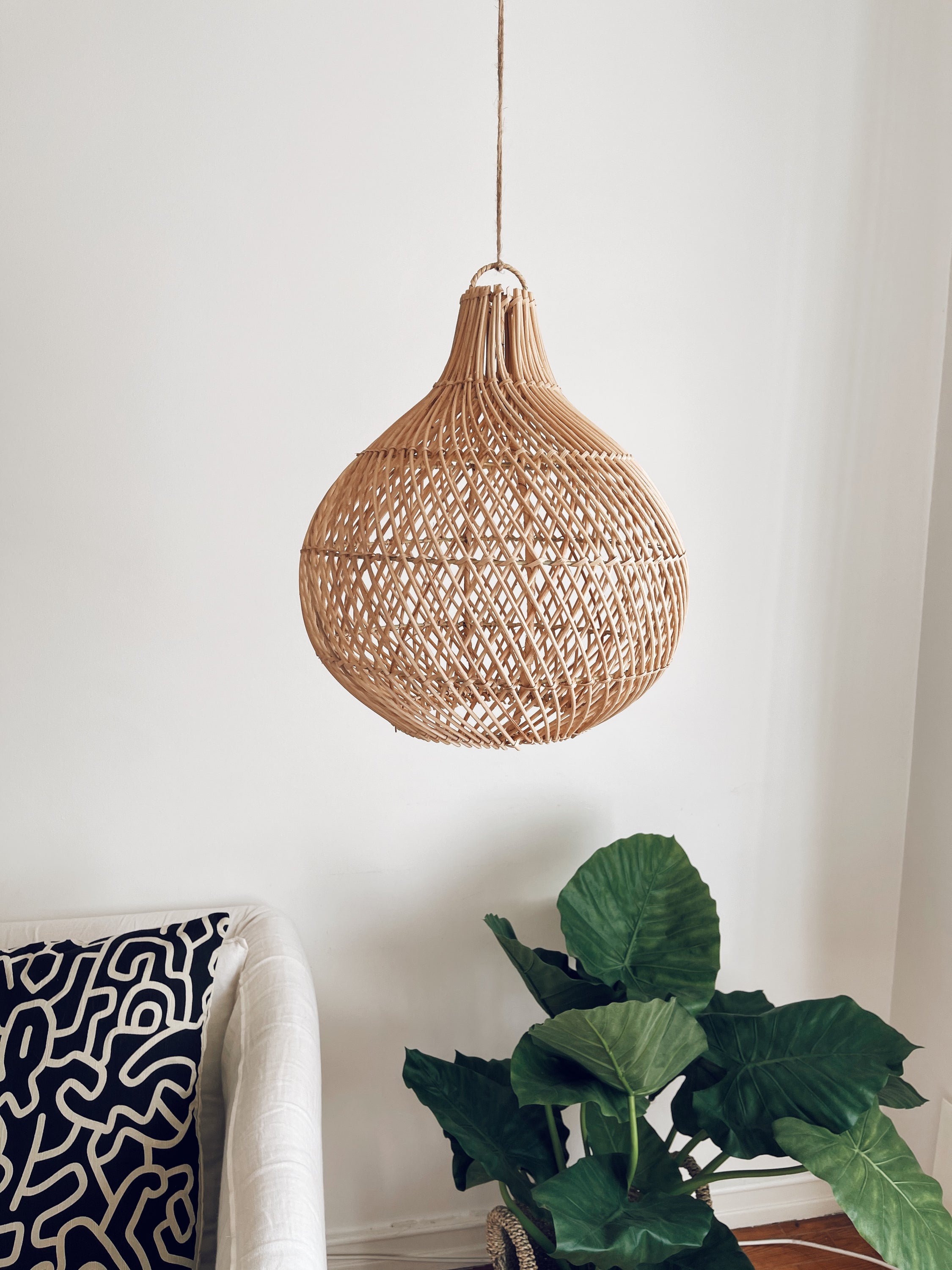 A beautifully handcrafted rattan lampshade featuring intricate Mandala patterns, perfect for adding a coastal touch to any interior.