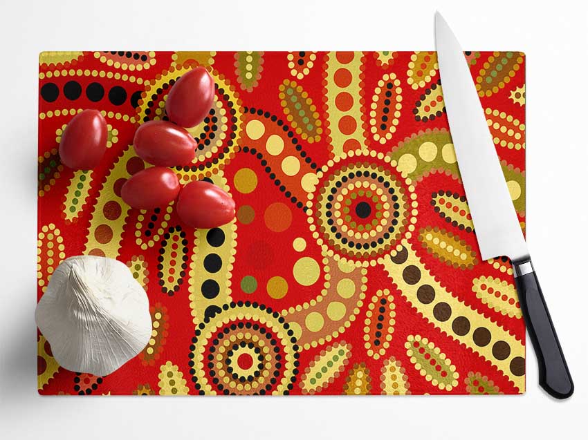 Aboriginal Red Tribal chopping board made of tempered glass with a chinchilla ripple effect and anti-slip feet.