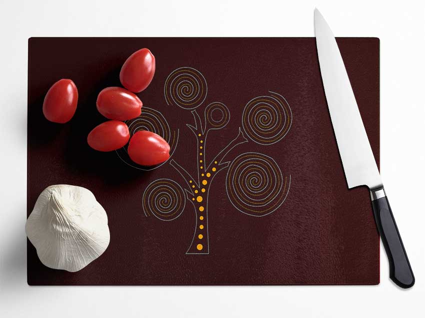Aboriginal Tree 3 chopping board made of tempered glass with a chinchilla ripple effect and anti-slip feet.
