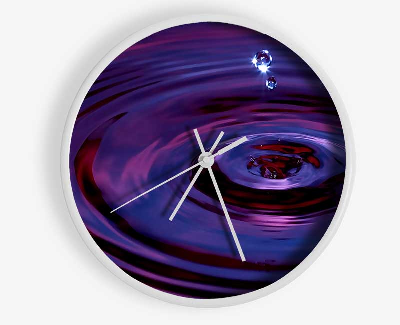 Abstract Drop clock made from natural bamboo with a round face and clear Plexiglas lens, available in black, white, and natural frame colors.