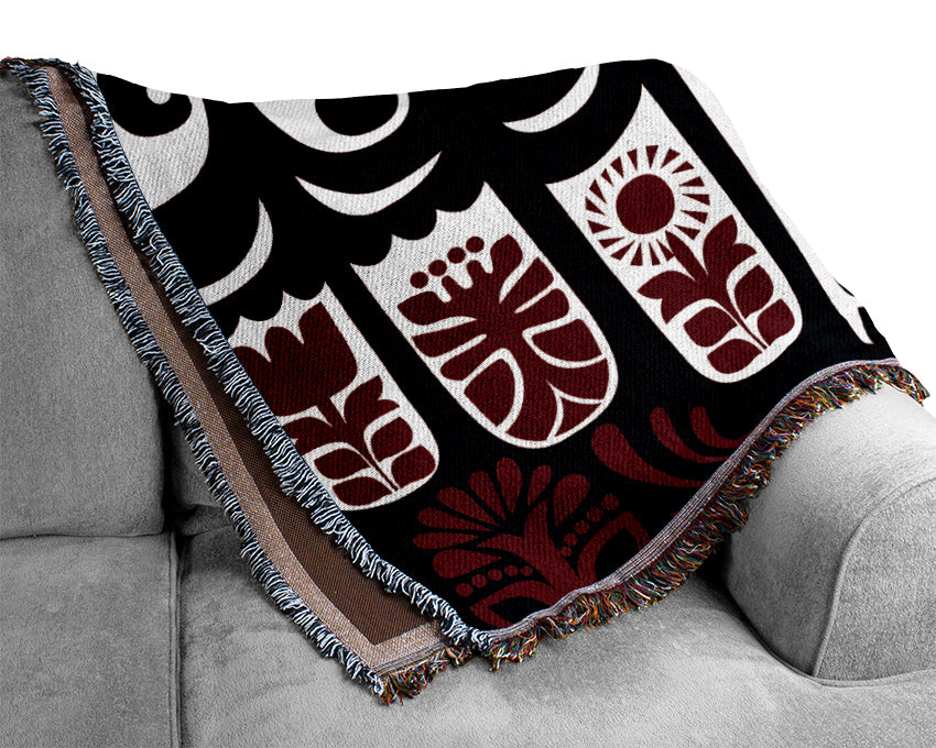 A luxurious Abstract Hills Maroon throw blanket made from 100% cotton, featuring a thermal weave for breathability, draped elegantly on a couch.