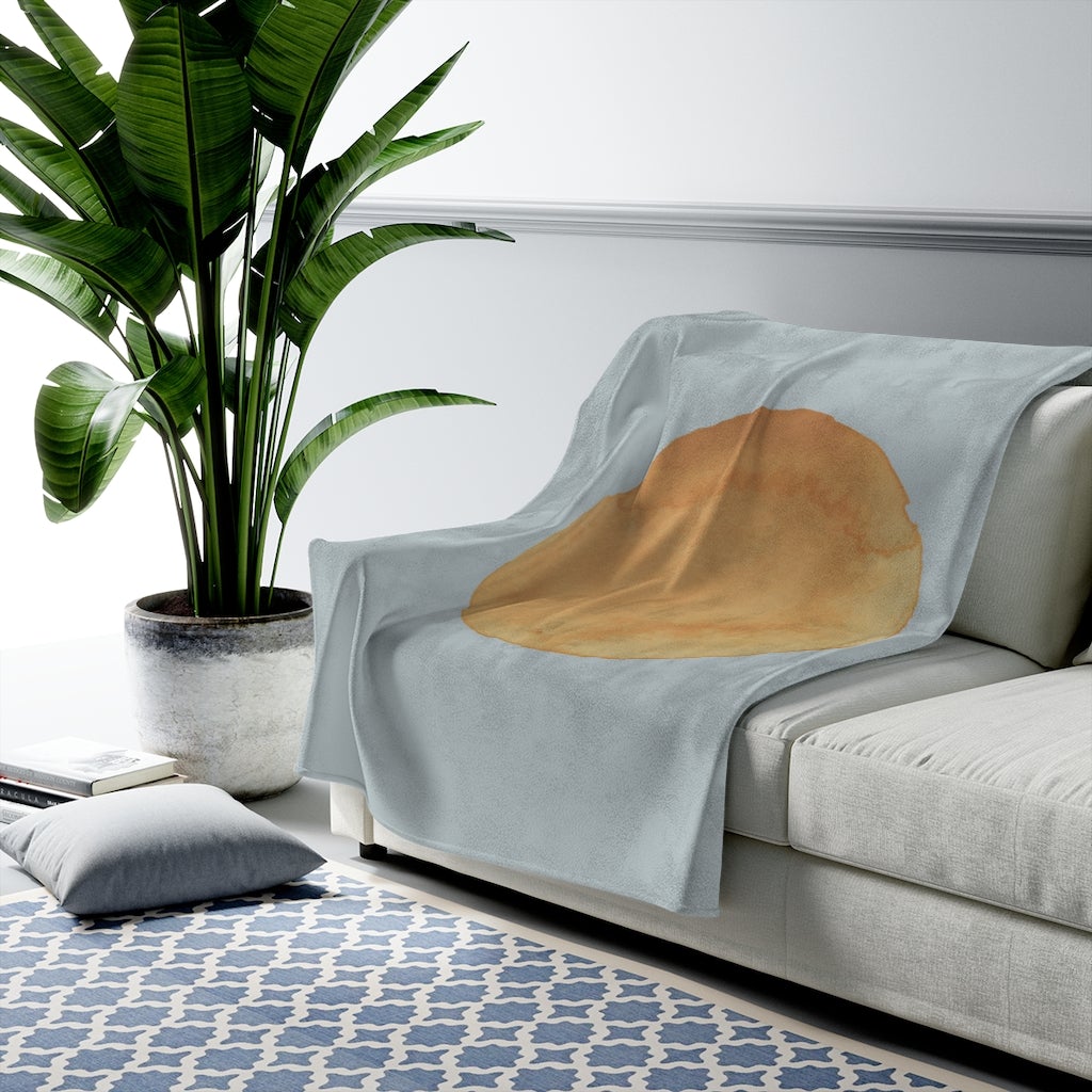 A cozy blue plush throw featuring abstract sun art design, available in three sizes, perfect for home decor.