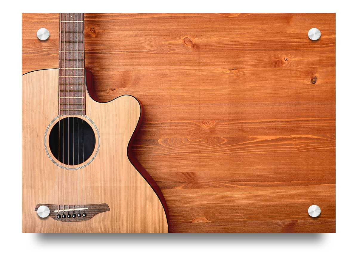 A vibrant acrylic print of an acoustic guitar, showcasing its intricate details and colors, ready to hang on a wall.